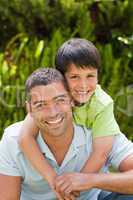 Father with his son hugging in the garden