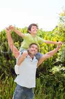 Father with his son playing in the garden