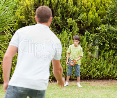 Son playing football with his father