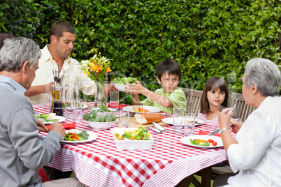 Happy family eating in the garden