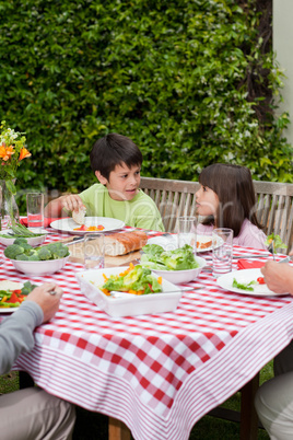 Happy family eating in the garden