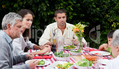 Happy family eating in the garden