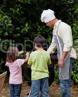 Family  having a barbecue in the garden