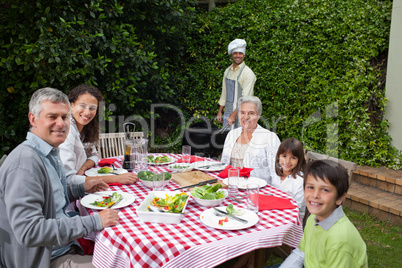 Happy family eating in the garden