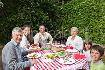 Happy family eating in the garden