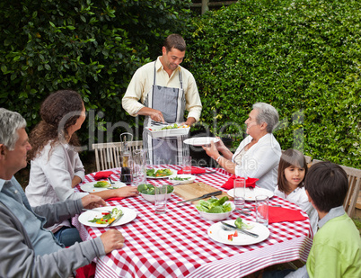 Man serving his family at the table