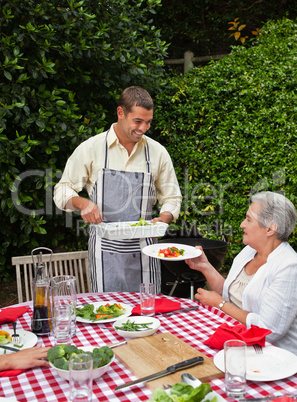 Man serving his family at the table