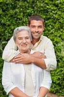 Man hugging his mother in the garden