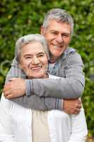 Mature couple hugging in the garden