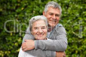 Mature couple hugging in the garden