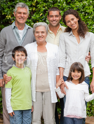 Portrait of a happy family looking at the camera in the garden