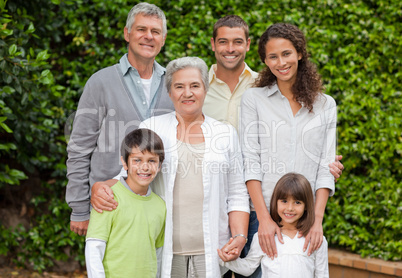 Portrait of a happy family looking at the camera in the garden