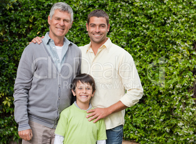 Radiant family looking at the camera in the garden Radiant family looking at the camera in the garden