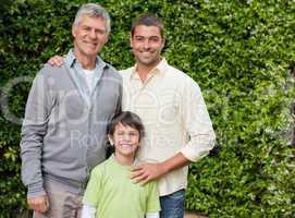 Radiant family looking at the camera in the garden