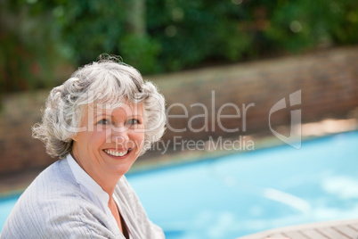 Smiling woman beside the swimming pool