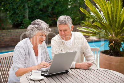 Retired couple working on their laptop