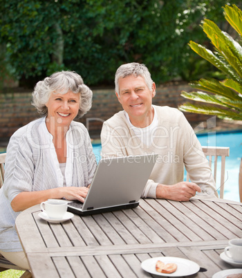 Retired couple working on their laptop