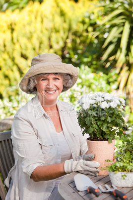 Senior woman with flowers in her garden