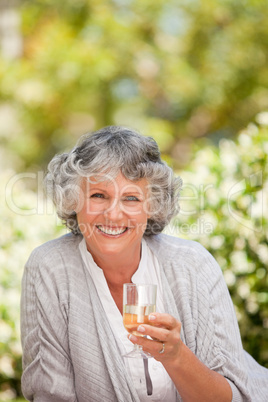 Smilimg woman with her drink of wine