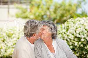 Man kissing his wife in the garden
