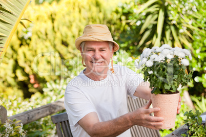 Senior man with flowers in his garden