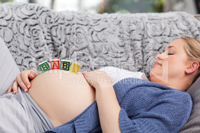 Pregnant young woman with cubes on her belly