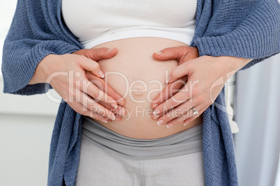 Couple's hand on the belly of the pregnant woman