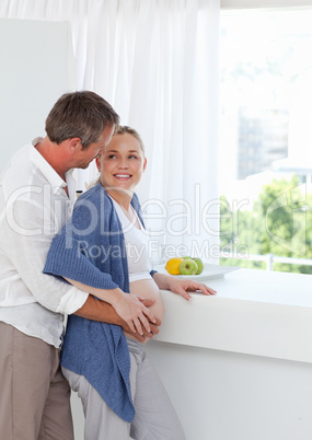 Couple hugging in the kitchen