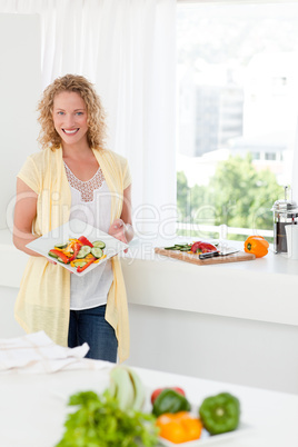 Woman showing her healthy food  in her kitchen
