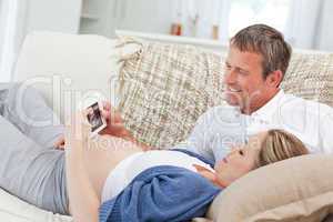 Couple looking at X-ray on their couch