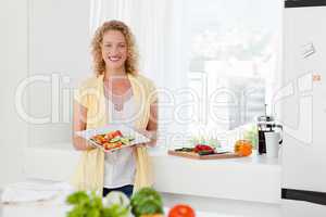 Woman showing her healthy food  in her kitchen