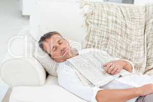 Exhausted man sleeping on the couch at home