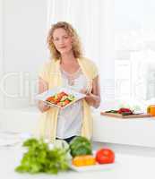 Woman showing her healthy food  in her kitchen