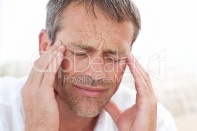 Man having a headache at home