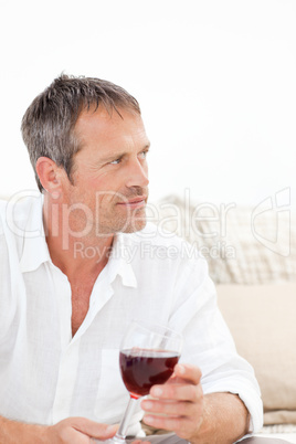 Handsome man drinking some red wine