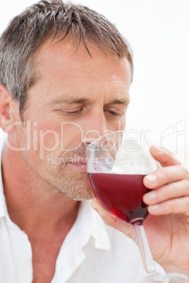 Handsome man drinking some red wine