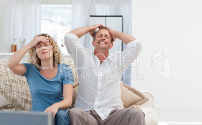 Lovers watching tv in the living room at home