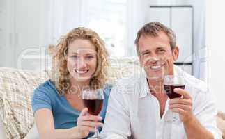 Couple drinking some red wine in the living room