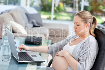 Worried pregnant woman calculating her domestic bills