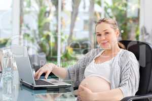 Worried pregnant woman calculating her domestic bills