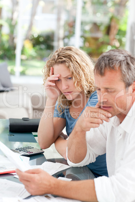 Desperate couple calculating their domestic bills