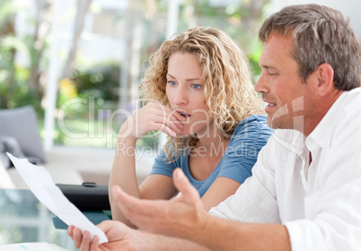 Desperate couple calculating their domestic bills