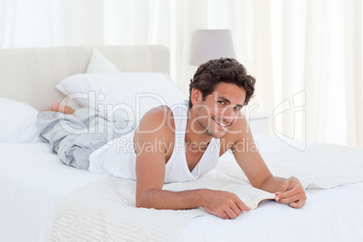 Man reading a book on his bed