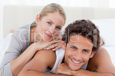 Beautiful couple lying down on their bed