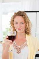 Woman looking at the camera with her drink of wine