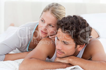 Beautiful couple lying down on their bed