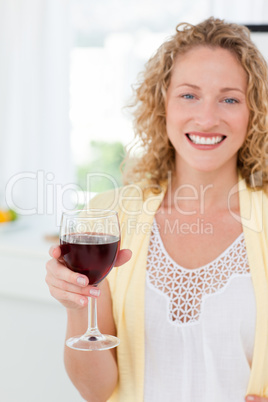 Woman looking at the camera with her drink of wine