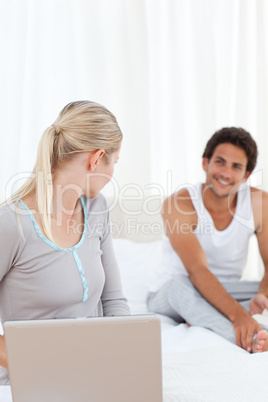 Woman talking with her boyfriend on the bed