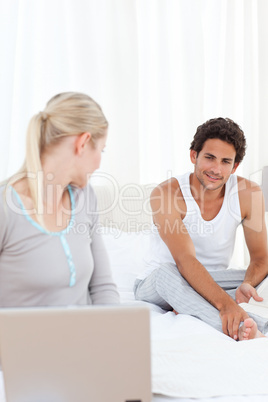 Woman talking with her boyfriend on the bed