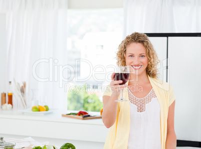 Woman looking at the camera with her drink of wine